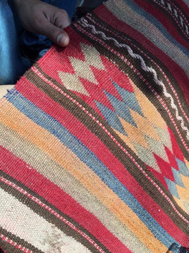 blog posts image, person holding a kilim