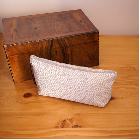 Tyana Handwoven Makeup/Pouch Bag, clutch cosmetic bag angled with decor box